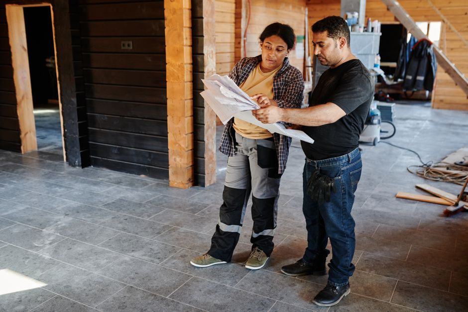 Contractor reviewing detailed kitchen renovation blueprints